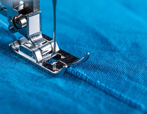 Sewing machine stitching fabric